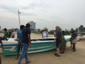 Jim and Yves helping local fishermen pull in their boats during our beach walk